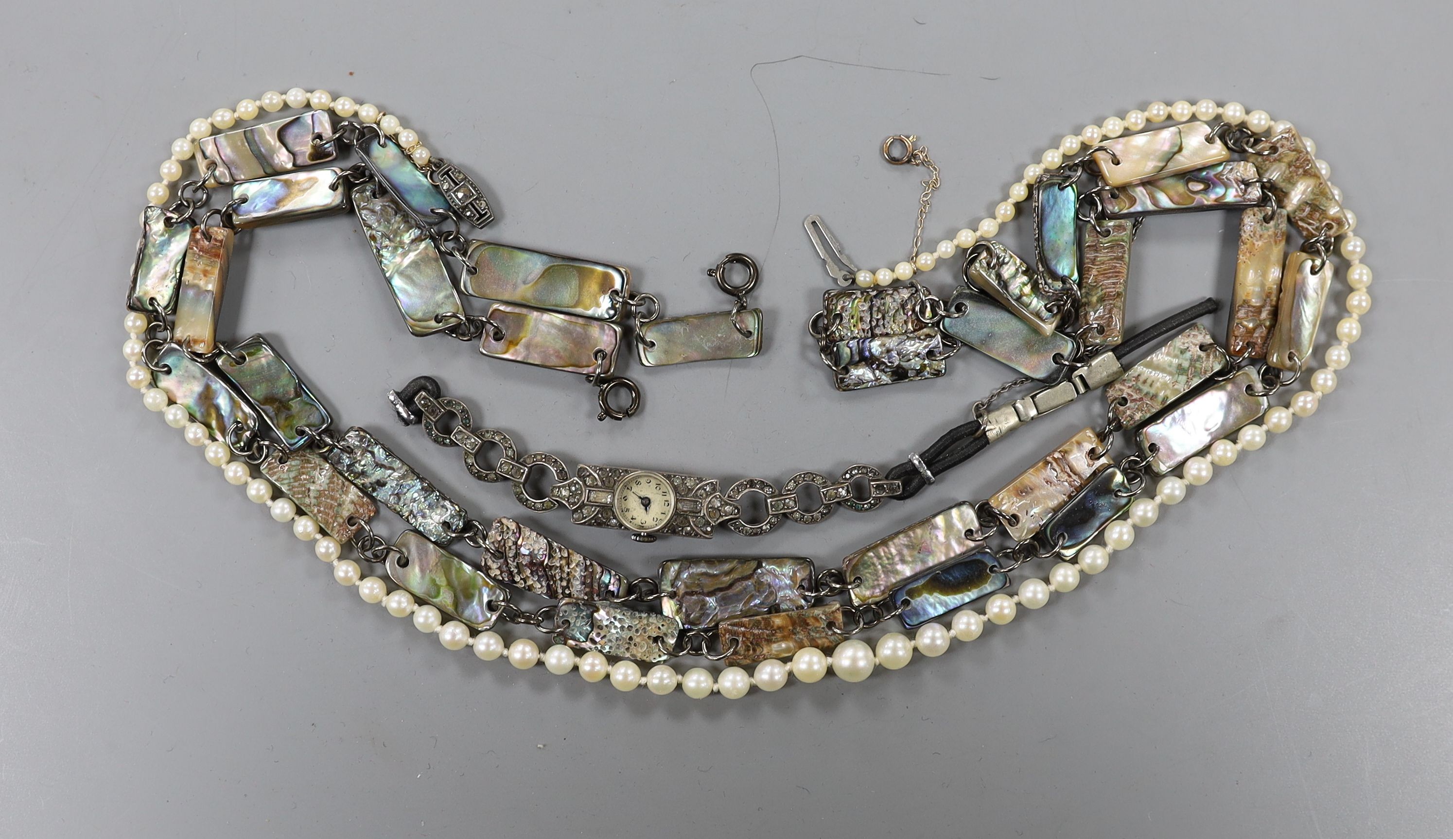 A single strand cultured pearl necklace, with marcasite clasp, a lady's silver and marcasite set wrist watch and tow paur shell set necklaces.